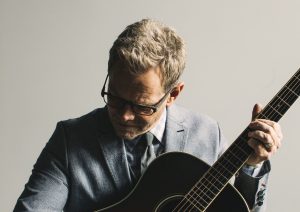 Steven Curtis Chapman playing on guitar